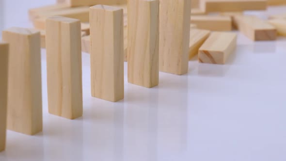 Domino Effect Row of Wooden Domino Falling Down on White Background