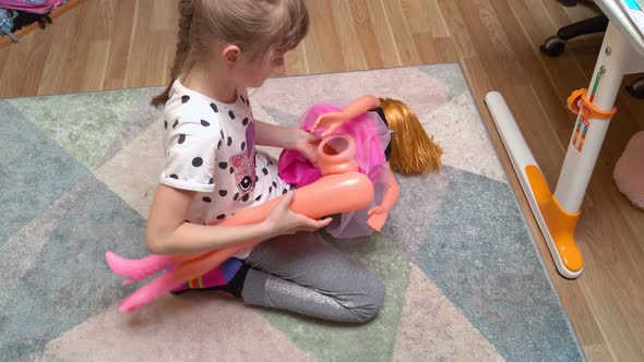 Girl Repairing A Doll