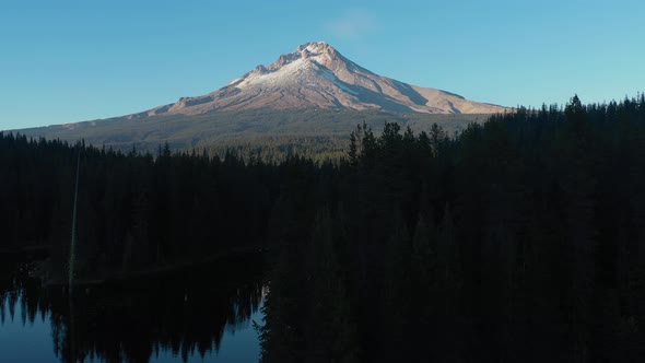 Aerial crane shot revealing Mt. Hood seen from Trillium Lake at sunset in Oregon.