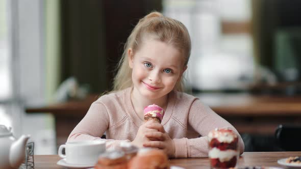 Portrait of Little Girl Posing with Ice Cream Cornet at Cafe