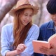 Slow motion romantic moment of young Asian couple reading book together. - VideoHive Item for Sale