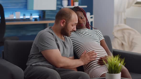 Interracial Couple Expecting Child in Living Room