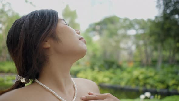 Cinematic View of a Lady Closing Her Eyes and Enjoying the Wind of Nature