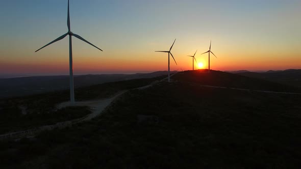 Aerial view of windmills at beautiful colorful sunset