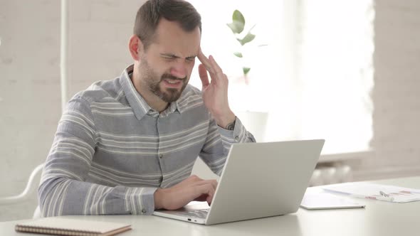 Distraught Adult Man with Headache at Work