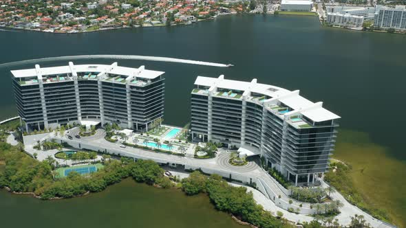 Yacht Is Sailing in the Bay. Modern Architecture Residential Complex with Pools