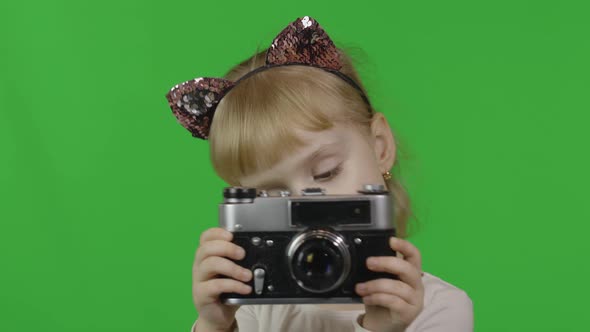 Girl in Cat Headband Taking Pictures on an Old Retro Photo Camera