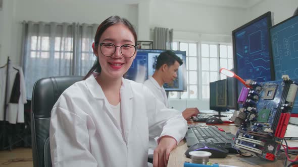 Asian Woman Smiling Charmingly Looking At Camera. Young Intelligent Female Scientist Work In Office