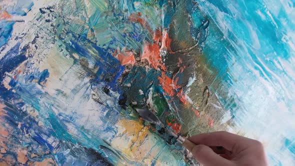 Artist's Hands Painting a Picture Closeup