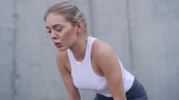 Exhausted Female Jogger Taking Break