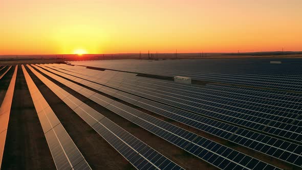 Top View of a Large Photovoltaic Power Station at Sunset