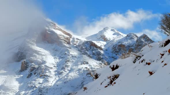 Rocky Foggy Mountain Peak In Snowy