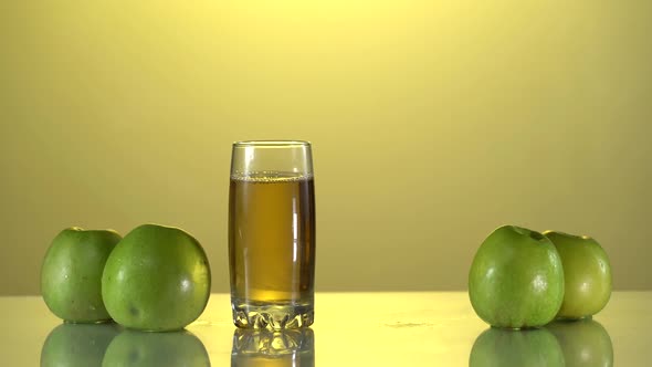 Man's Hand Takes a Fresh Apple Juice From the Table