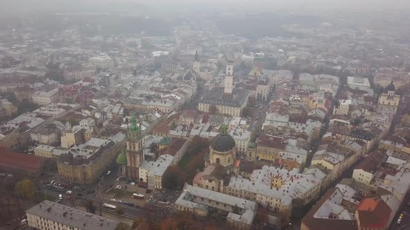 Aerial: Cityscape of Lviv in misty weather