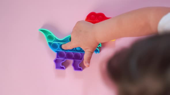 Popit Rainbow Toy in Rainbow Colours and Dino Shape