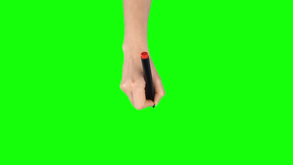 Female Hand with Red Marker Is Writing on Green Screen Background. Close Up