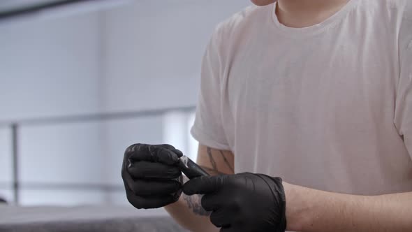 Young Ginger Man Getting Ready for Doing a Tattoo