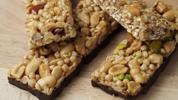 Cereal superfood energy bars with almond nuts, dry fruits, raisins chocolate on the wood table