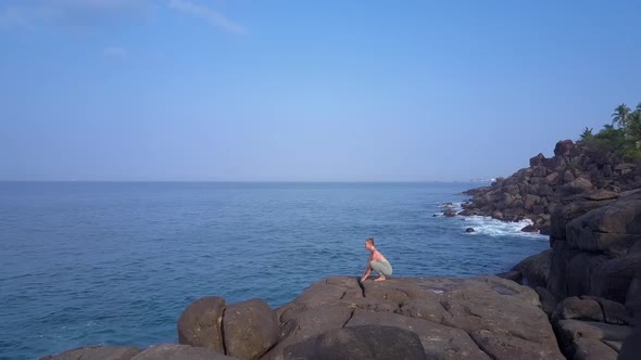 Tropical Nature with Blue Ocean and Woman Practicing Yoga