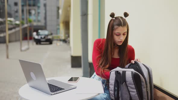 Freelance Woman in a Summer Cafe Preparing to Work