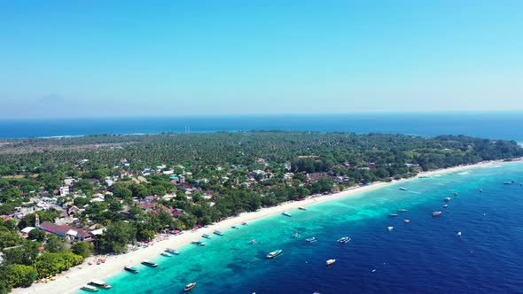 Vivid colors of tropical island with white beach washed by blue azure calm sea where many boats floa