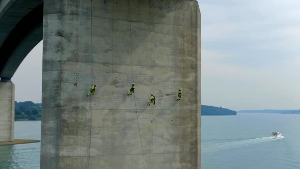 Safety Inspectors Working at Height on a Concrete Bridge Checking for Cracks