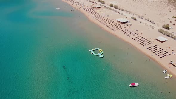 Aerial View Of Tsambika Beach With Inflatable Island At Water Park In Rhodes, Greece.
