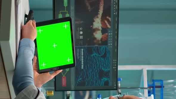 Vertical Video Scientist Holding Tablet with Green Mockup