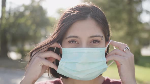 Beautiful woman looking at camera with medical mask