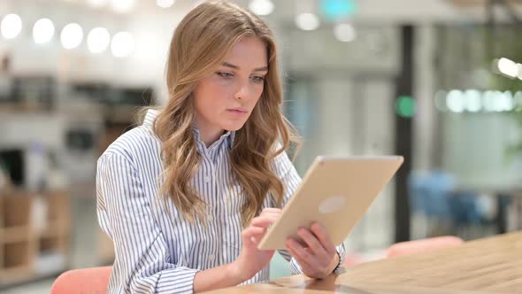 Excited Businesswoman Celebrating Success on Tablet