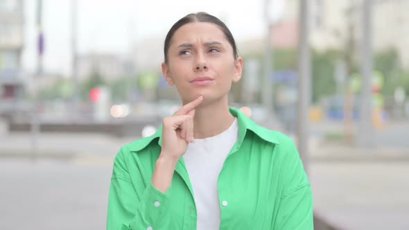 Portrait of Pensive Hispanic Woman Thinking Outdoor