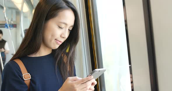 Woman use of mobile phone on train