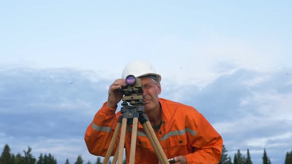 Explorer Looks Through Dumpy Level Binocular and Types