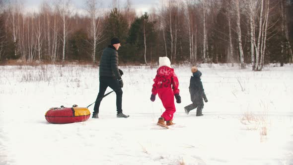 Family Playing with Snow Outdoors