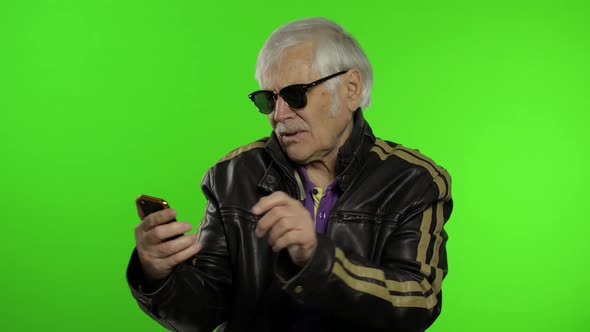 Elderly Stylish Caucasian Grandfather Man Using Smartphone for Online Shopping