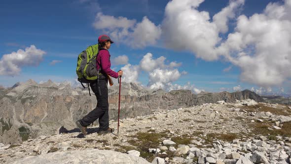 Backpacker Hiking in Montain Landscape. Summer Adventures on Dolomites Alps