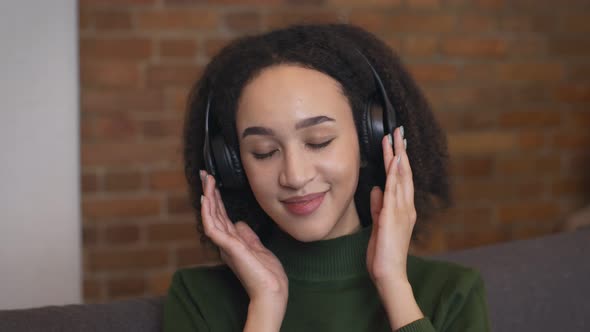Close Up Portrait of Relaxed African American Woman Enjoying Music in Wireless Headphones