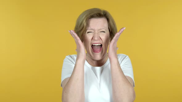 Screaming Angry Old Woman Isolated on Yellow Background