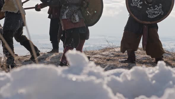 Legs of Viking Warriors, during attack at winter time. Medieval Reenactment. alt