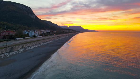 sunset on the beach in autumn, drone on the calm sea