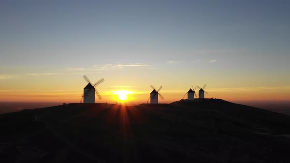 Aerial view of windmills in the countryside in Spain at sunrise