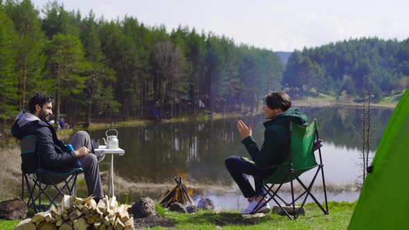 Forest, lake and people camping.