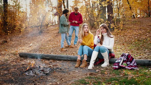 Young Friends Enjoying Picnic in Autumn Forest