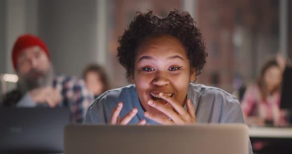 Excited Female Feeling Euphoric Celebrating Achievement Working Late in Office