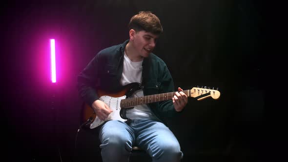 Musician Playing the Guitar During a Live Performance