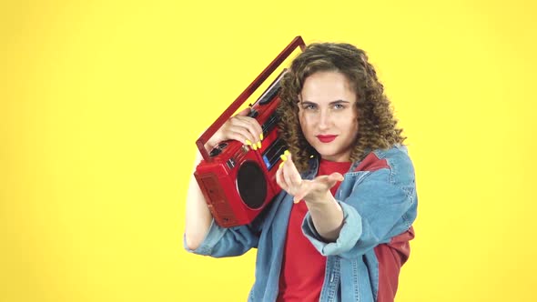 Girl Enjoying the Music and Dancing with the Red Boombox on Her Shoulder, Retro Style, Slow Motion