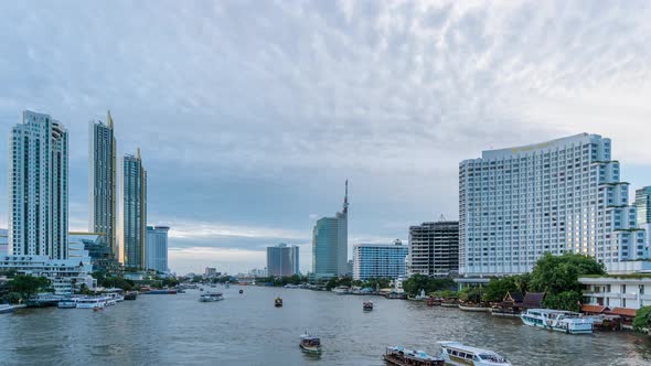 Bangkok city center waterfront and Chao Phraya River during twilight; day to night - Time Lapse