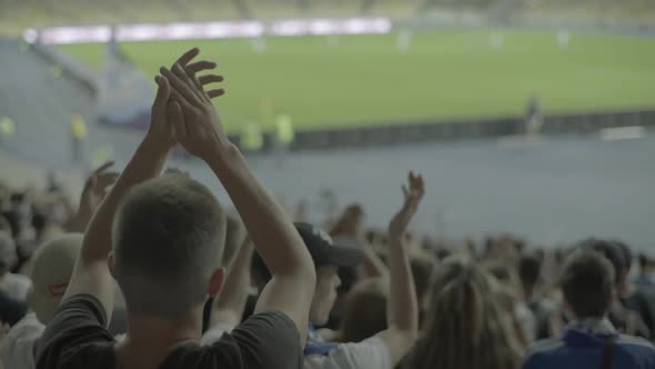 Fans at the Stadium During the Match. Slow Motion.