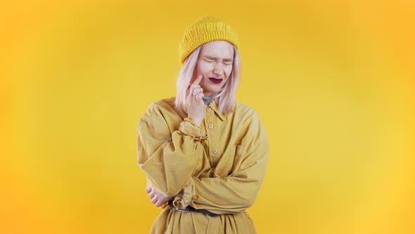 Young Pretty Woman with Tooth Pain on Yellow Studio Background. Toothache