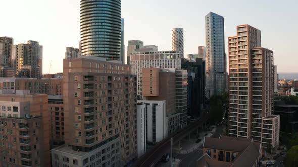 Crane Up Footage of Futuristic Skyscrapers in Evening Sun